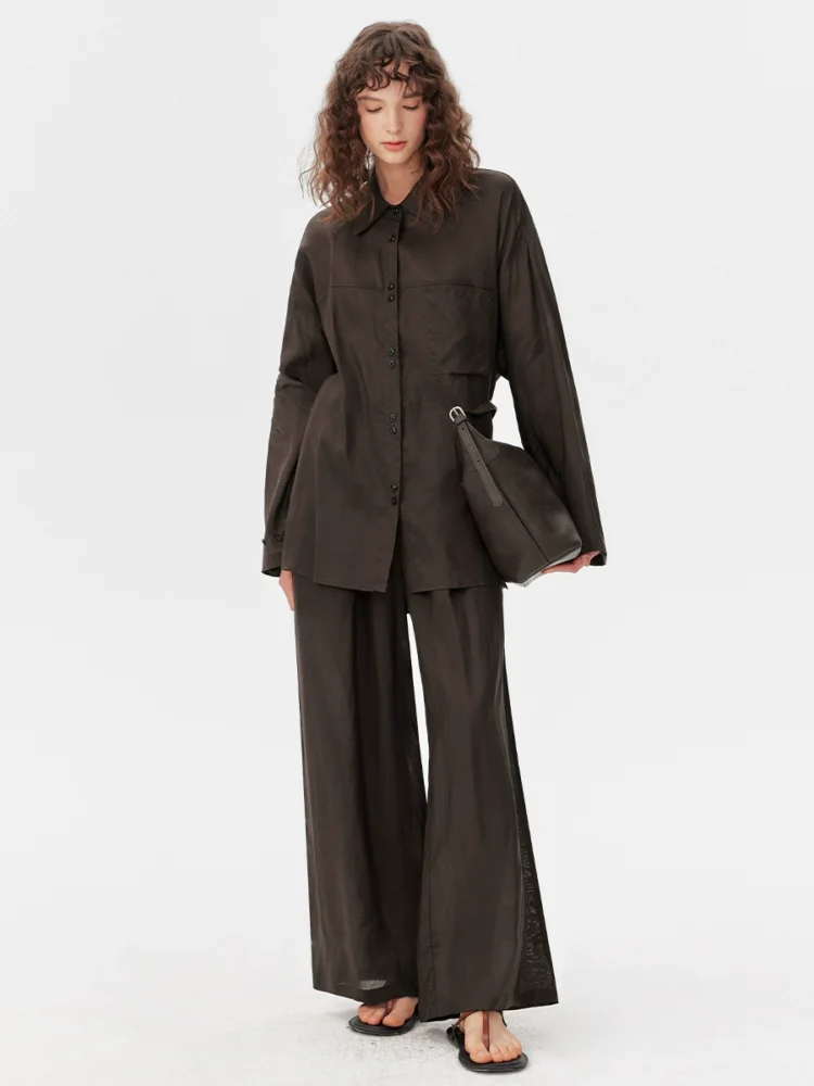 A light shirt and loose trousers suit