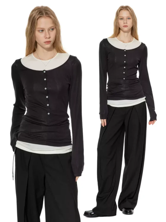 A knitted sweater is paired with two T-shirts