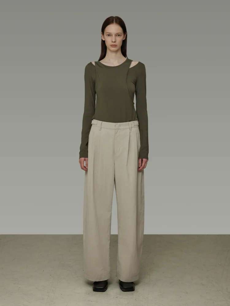 Women in double-pleated high-waisted wide-leg pants
