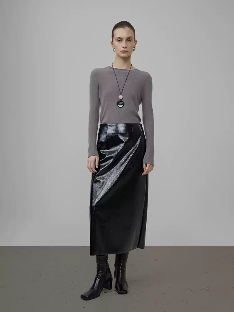 A woman in a high-waisted black leather dress