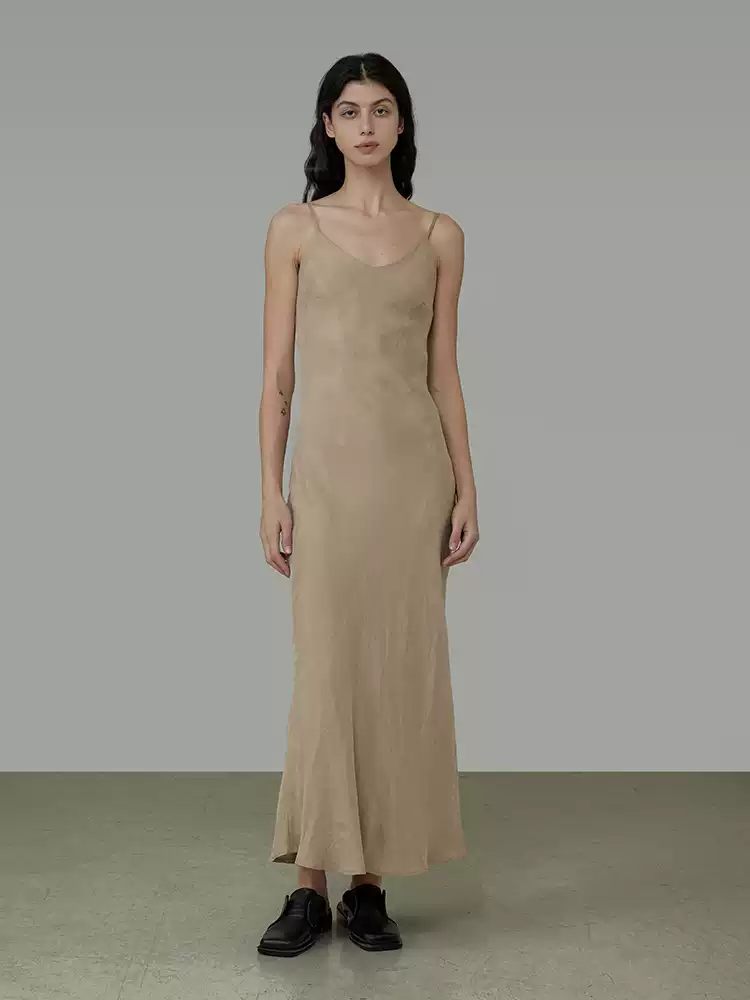 A waist-cinching halter dress with a smooth and flowing feel