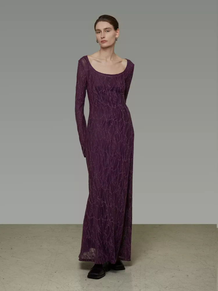 A woman in a large U-neck jacquard dress