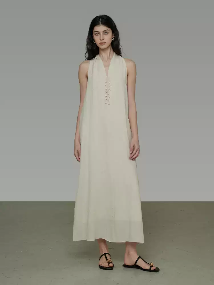 A woman in a V-neck halter dress