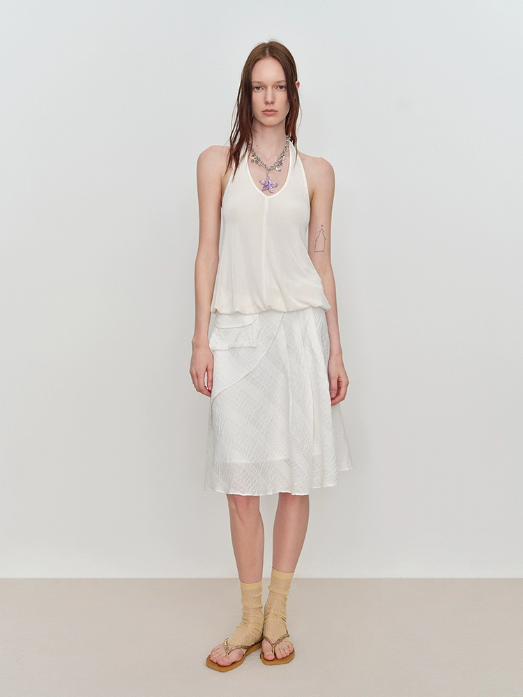 A white, irregular, flowing and drooping umbrella skirt