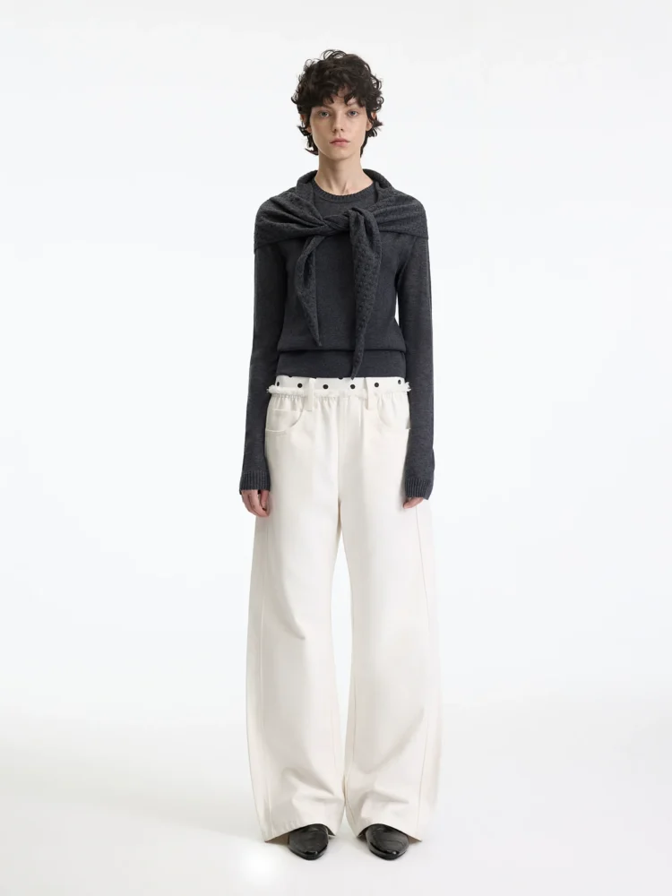 A woman in beige polka dot casual pants