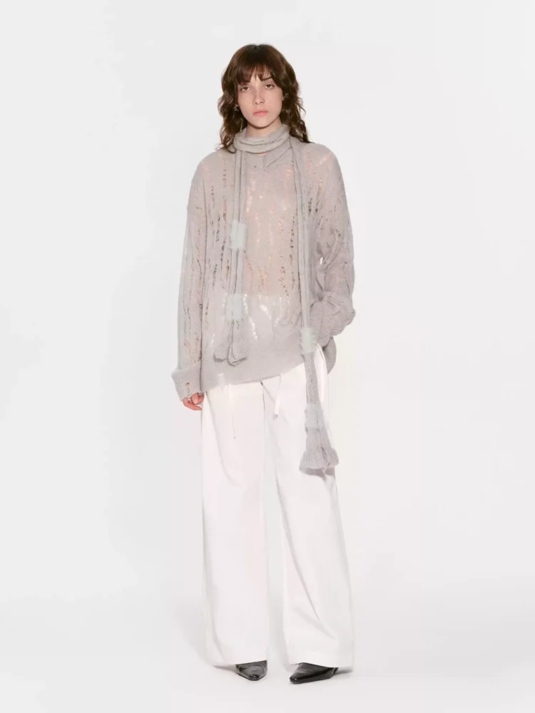 A perforated and hollowed-out knitted sweater with a scarf