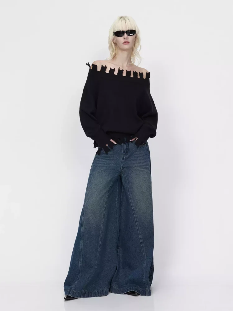 A black, stylish one-shoulder sweater with loose edges