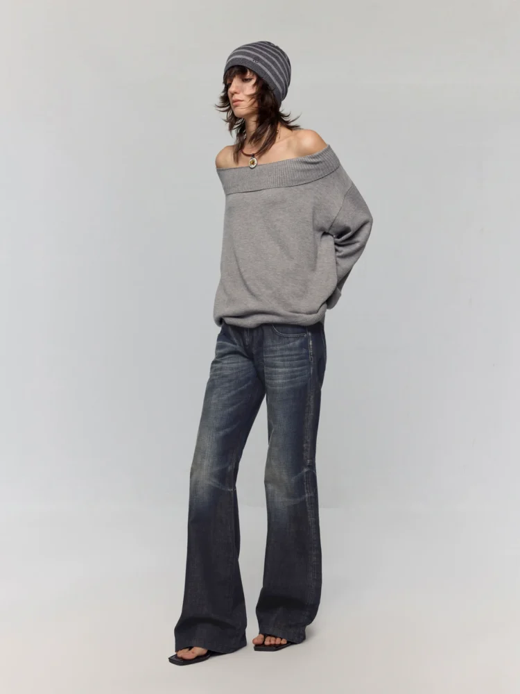 A knitted sweater with adjustable neckline straps