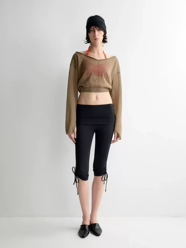 A loose, short knitted smock with a one-shoulder neckline