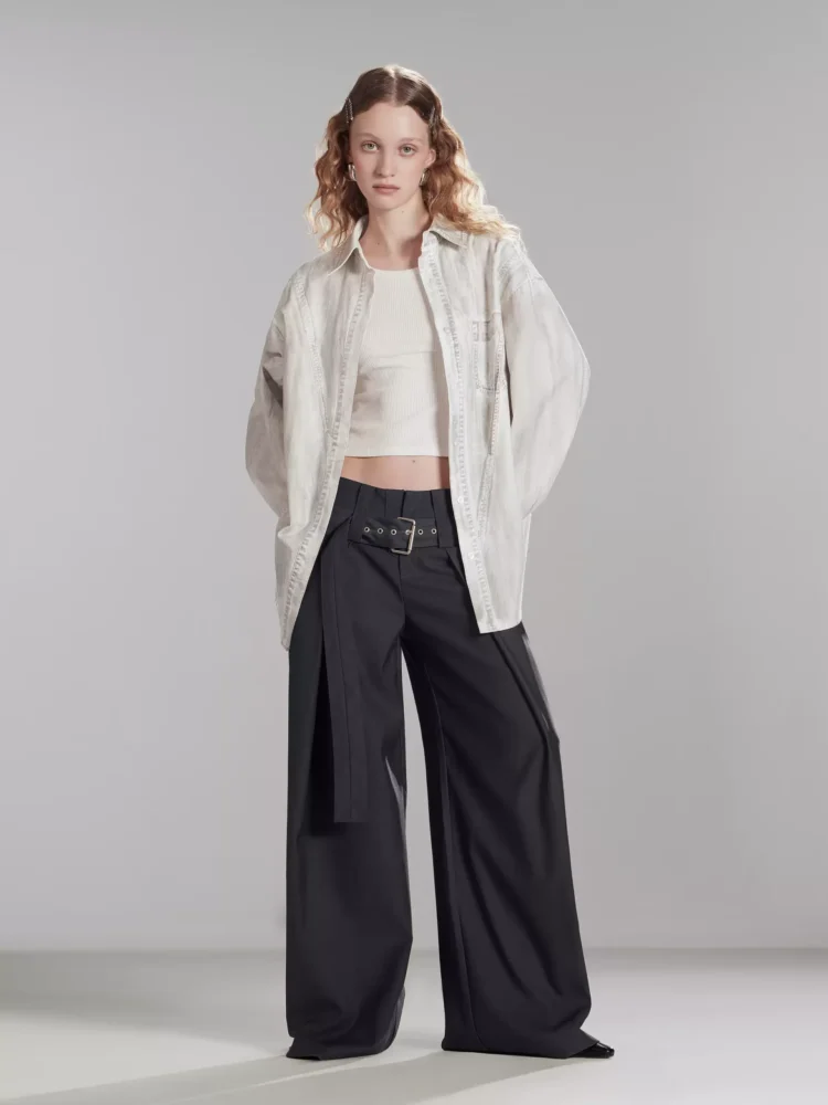 A woman wearing an asymmetrical hand-dyed shirt