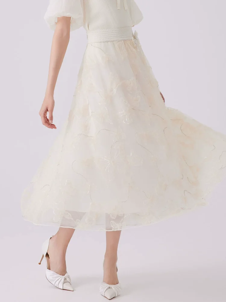 a long A-line skirt with mesh butterfly embroidery