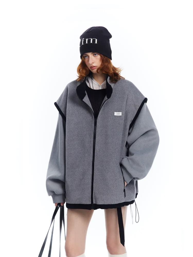 A woman in a grey patchwork woolen coat