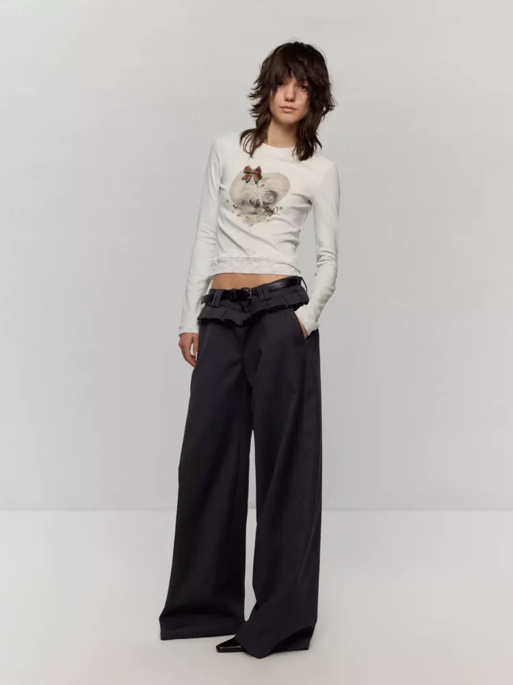 A figure-hugging long-sleeved T-shirt with patchwork lace trim