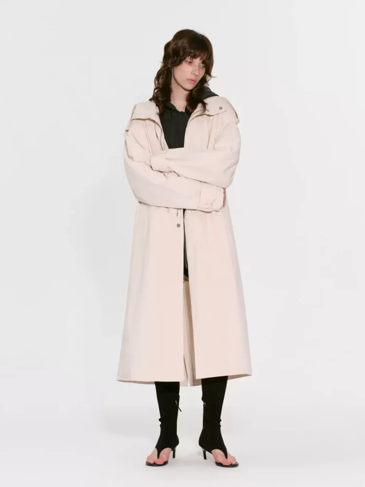 A woman in a high-end silhouette trench coat