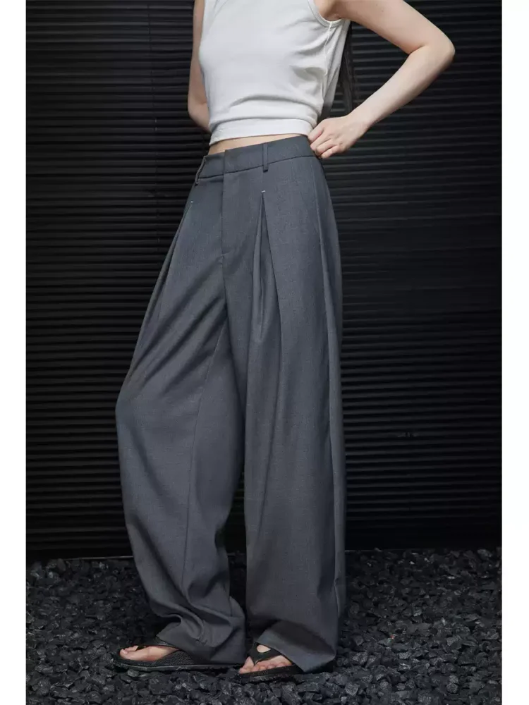 A woman in loose and slimming grey trousers