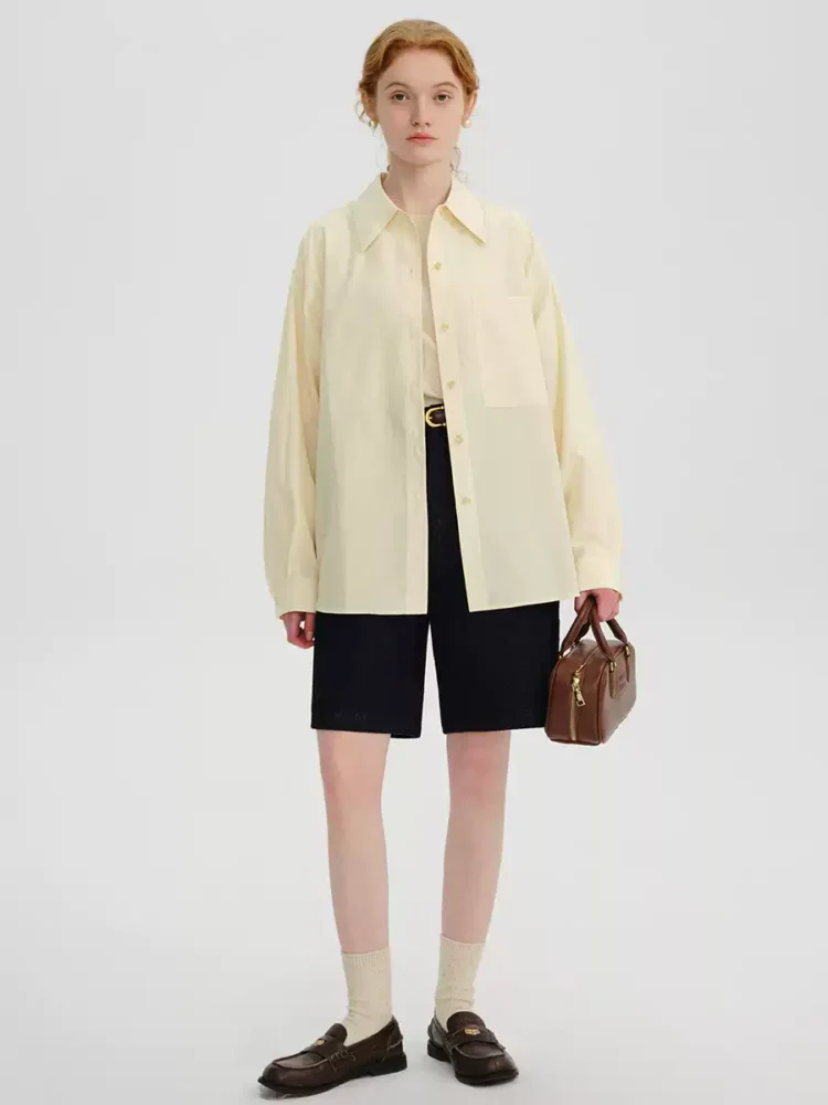 A woman in a cream-colored shirt